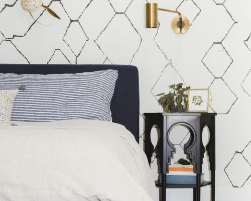 Minimal bedroom decor with a golden lamp